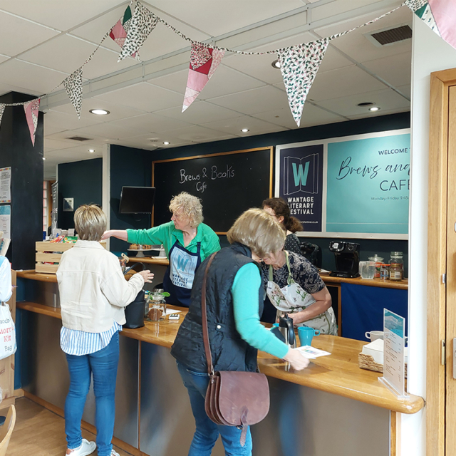 Brews and Books Cafe at Wantage Literary Festival. There are staff members manning the til and serving customers.