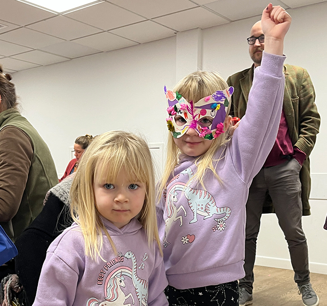 A child wearing a decorative mask.
