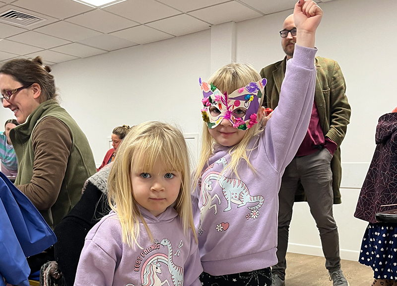 A child wearing a decorative mask.